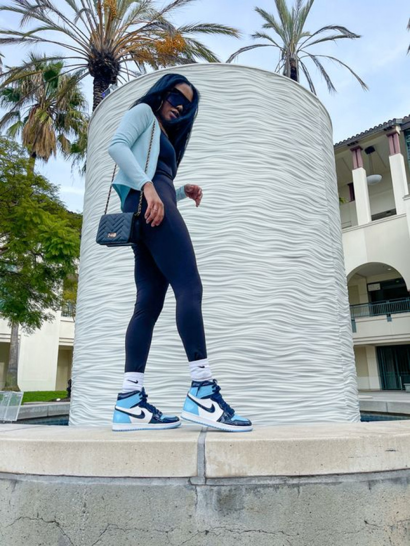 Air Jordan 1 'University Blue' Sneakers On Vacation With Black Leggings, And Hooded Top: active pants,  light-hearted  